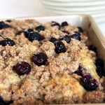 Blueberry Greek yogurt coffee cake in an 8x8 pan with cinnamon streusel and fresh blueberries on top