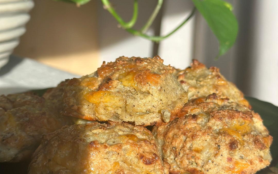 Golden brown cheesy garlic biscuits made with cottage cheese and almond flour on a parchment lined baking sheet.