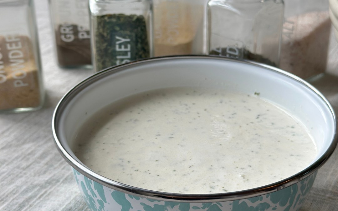Restaurant style ranch dressing in a glass jar with dried herbs, ready for dipping and drizzling.